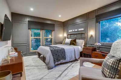 a bedroom with a large bed and a living room at Projector - Pool Table - 15min DT - Pets OK - BBQ in Los Angeles