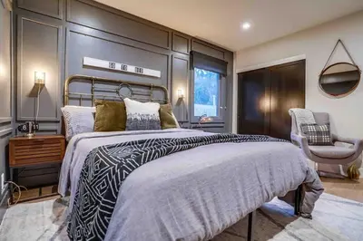 a bedroom with a large bed and a chair at Projector - Pool Table - 15min DT - Pets OK - BBQ in Los Angeles