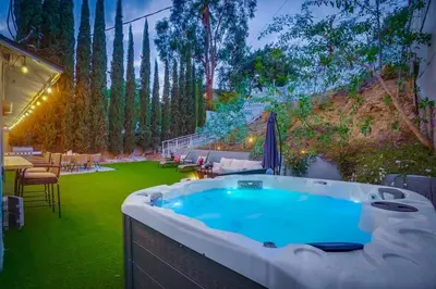 a jacuzzi tub in a garden with trees at Hollywood Hills Retreat - Private GYM & STEAM ROOM in Los Angeles