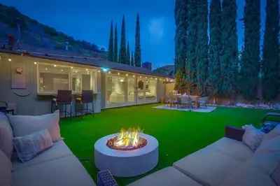 a backyard with a fire pit in the grass at Hollywood Hills Retreat - Private GYM & STEAM ROOM in Los Angeles