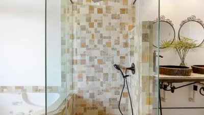 a bathroom with a shower with a glass door at Designer Retreat w Pool Firepits Panoramic Views The Lake House at Malibu in Agoura Hills