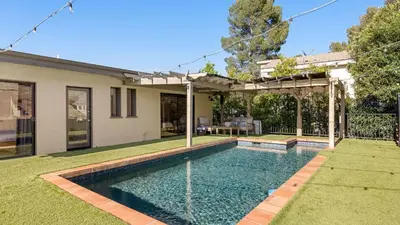 a swimming pool in the yard of a house at Designer Retreat w Pool Firepits Panoramic Views The Lake House at Malibu in Agoura Hills