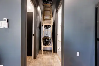 a hallway with a laundry room with two washes at New and Modern Casita VIP in San Dimas
