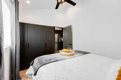 a bedroom with a bed with a bowl of fruit on it at New and Modern Casita VIP in San Dimas