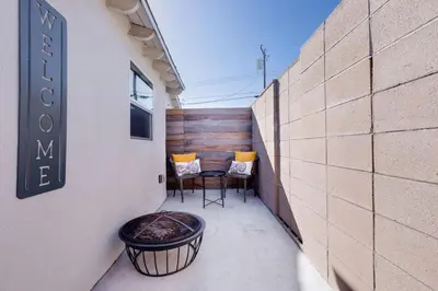 a small balcony with a table and chairs on a building at New and Modern Casita VIP in San Dimas