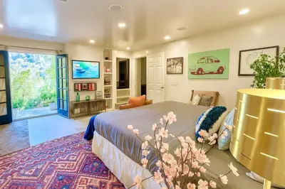 a bedroom with a bed and a living room at Hollywood Hills Spa Retreat Oasis with Tree Top Views, Private Jacuzzi Style Tub, Steam Room, Magical Half Acre Acre Garden and Patio, Free Parking for 2 cars, in LA's most Serene, Central Desirable Area in Los Angeles