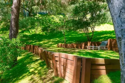 a wooden fence in a field with trees at Hollywood Hills Spa Retreat Oasis with Tree Top Views, Private Jacuzzi Style Tub, Steam Room, Magical Half Acre Acre Garden and Patio, Free Parking for 2 cars, in LA's most Serene, Central Desirable Area in Los Angeles