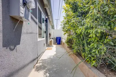 an empty alley with plants next to a building at NEW and Modern Cozy Flat in Southern California in Covina