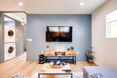 a living room with a flat screen tv on a wall at NEW and Modern Cozy Flat in Southern California in Covina