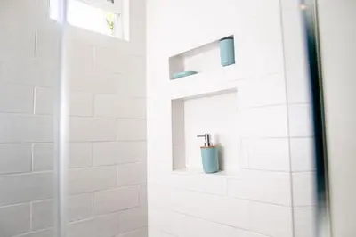 a white bathroom with a shower with a sink at NEW and Modern Cozy Flat in Southern California in Covina
