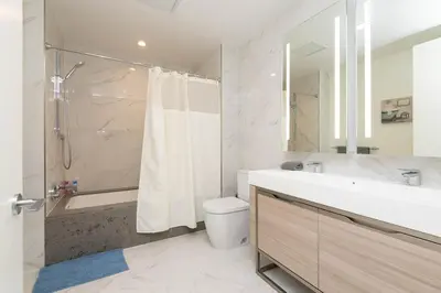 a bathroom with a sink and a toilet and a shower at Snug 3BR HighRise with Pool, Spa & Rooftop Views in Los Angeles