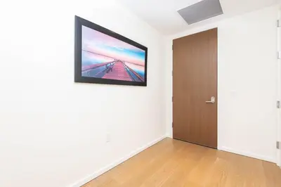 a room with a door and a television on the wall at Snug 3BR HighRise with Pool, Spa & Rooftop Views in Los Angeles