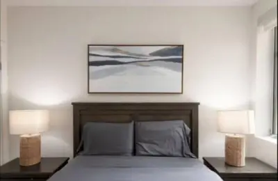 a bedroom with a bed with two nightstands and two lamps at Walk to Santa Monica Beach Pier Boardwalk Venice in Los Angeles