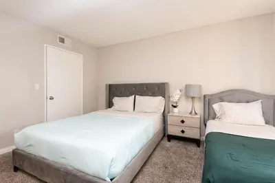 a bedroom with two beds and a night stand at 2BR Hollywood Apt with Rooftop Pool & Stunning Views in Los Angeles