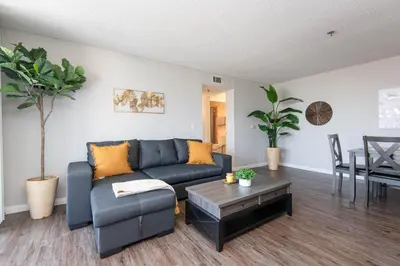 a living room with a blue couch and a table at Modern Escape in Hollywood with Rooftop & City Views in Los Angeles