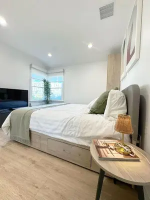 a bedroom with a large bed and a table at Bright and Chic 3BR-3BA by Century City - FH-BV in Los Angeles