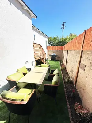 a patio with a table and chairs on the grass at Bright and Chic 3BR-3BA by Century City - FH-BV in Los Angeles