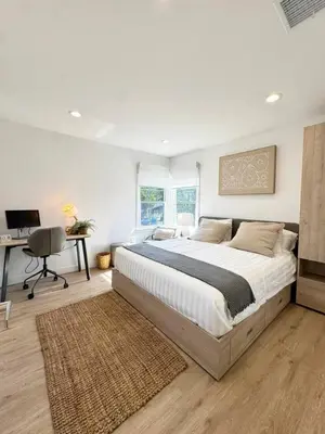 a bedroom with a large bed and a desk at Bright and Chic 3BR-3BA by Century City - FH-BV in Los Angeles