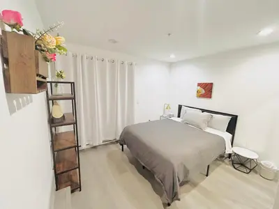 a bedroom with a bed and a book shelf at LA Modern Street View Glass Window 2BR in North Sherman Way