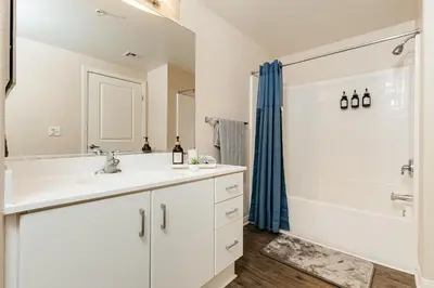 a white bathroom with a sink and a shower at Stunning 2 bedroom near by The Grove in Los Angeles