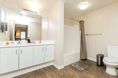 a white bathroom with a toilet and a sink at Stunning 2 bedroom near by The Grove in Los Angeles