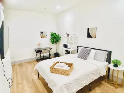 a bedroom with a bed with a basket on it at Modern New Studio Cozy&Prime Location in North Sherman Way