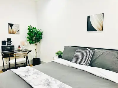 a bedroom with a bed and a desk with a computer at Modern New Studio Cozy&Prime Location in North Sherman Way