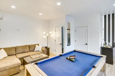a living room with a couch and a pool table at 4 Mi to SoFi Stadium Pet-Friendly LA Area Home in Los Angeles