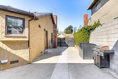a building with a grill on the side of it at 4 Mi to SoFi Stadium Pet-Friendly LA Area Home in Los Angeles