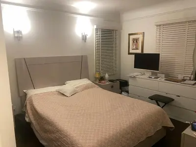 a bedroom with a bed and a desk with a computer at Spanish Cottage on Rosewood Avenue, Los Angeles , Melrose Village in Los Angeles