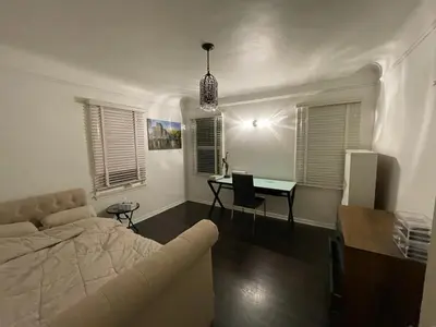 a living room with a couch and a desk in it at Spanish Cottage on Rosewood Avenue, Los Angeles , Melrose Village in Los Angeles