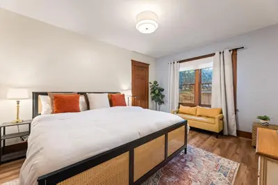 a bedroom with a large bed and a window at Bright Coastal Escape 4 Bedroom 2 Bath Near CSULB Long Beach Airport and Beach in Long Beach