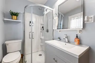 a bathroom with a shower and a toilet and a sink at Bright Coastal Escape 4 Bedroom 2 Bath Near CSULB Long Beach Airport and Beach in Long Beach