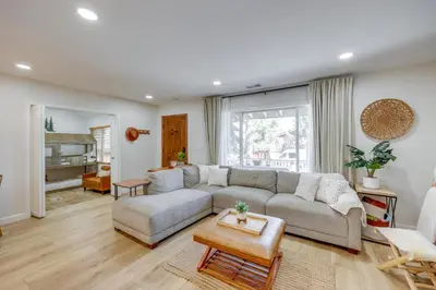 a living room with a couch and a table at Walk to Big Bear Marina Modern Home with Hot Tub! in Big Bear Lake