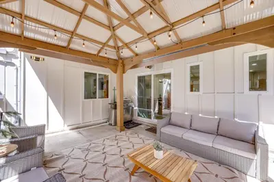 a living room with a couch and a table at Walk to Big Bear Marina Modern Home with Hot Tub! in Big Bear Lake