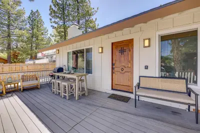 a porch with benches and a table and a door at Walk to Big Bear Marina Modern Home with Hot Tub! in Big Bear Lake