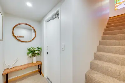 a staircase in a house with a mirror and a door at Walk to The Village ShopsandEats Big Bear Lake Home in Big Bear Lake