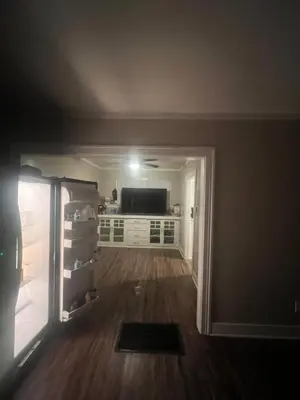 an empty living room with a refrigerator and a television at Living downtown in Long Beach
