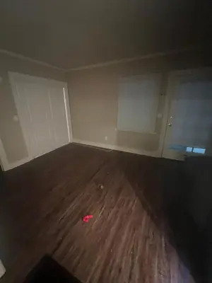 an empty room with a wooden floor and white walls at Living downtown in Long Beach