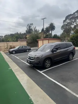 a gray van parked in a parking lot at Haystack Motel in Long Beach