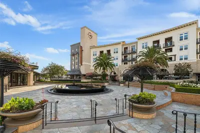 a courtyard with a building with a clock tower at Premier Suites at Marina-Venice with Luxe Pool, Gym & Hot Tub & More in Los Angeles