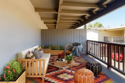 a patio with a couch and a table on a balcony at Premier Suites at Marina-Venice with Luxe Pool, Gym & Hot Tub & More in Los Angeles
