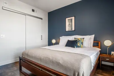 a bedroom with a large bed with blue walls at Culver City 1BR w Pool Gym WD nr Downtown LAX-173 in Los Angeles