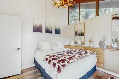 a bedroom with a large bed and a window at Cielo Ridge in Twin Peaks
