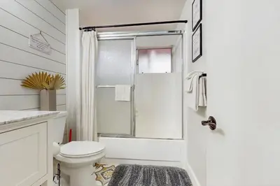 a white bathroom with a toilet and a shower at Cielo Ridge in Twin Peaks