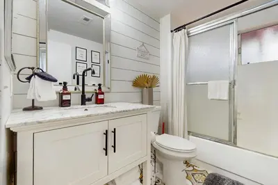 a white bathroom with a toilet and a sink at Cielo Ridge in Twin Peaks