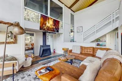 a living room with a couch and a fireplace at Cielo Ridge in Twin Peaks