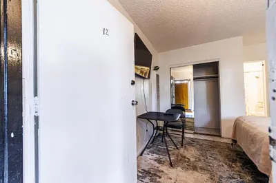 a bedroom with a bed and a desk in a room at Relaxing Studio 12 in Los Angeles