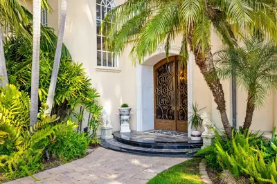 a entrance to a house with palm trees and a door at #Marbella Lane - Tranquil Country Escape Getaway in Placentia