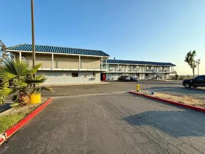 an empty parking lot in front of a building at Circle Inn Hotel - Jurupa Valley Riverside 60 Fwy in Riverside